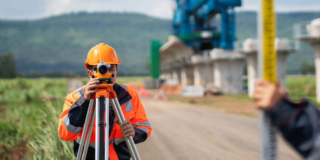 Man in hardhat performing survey